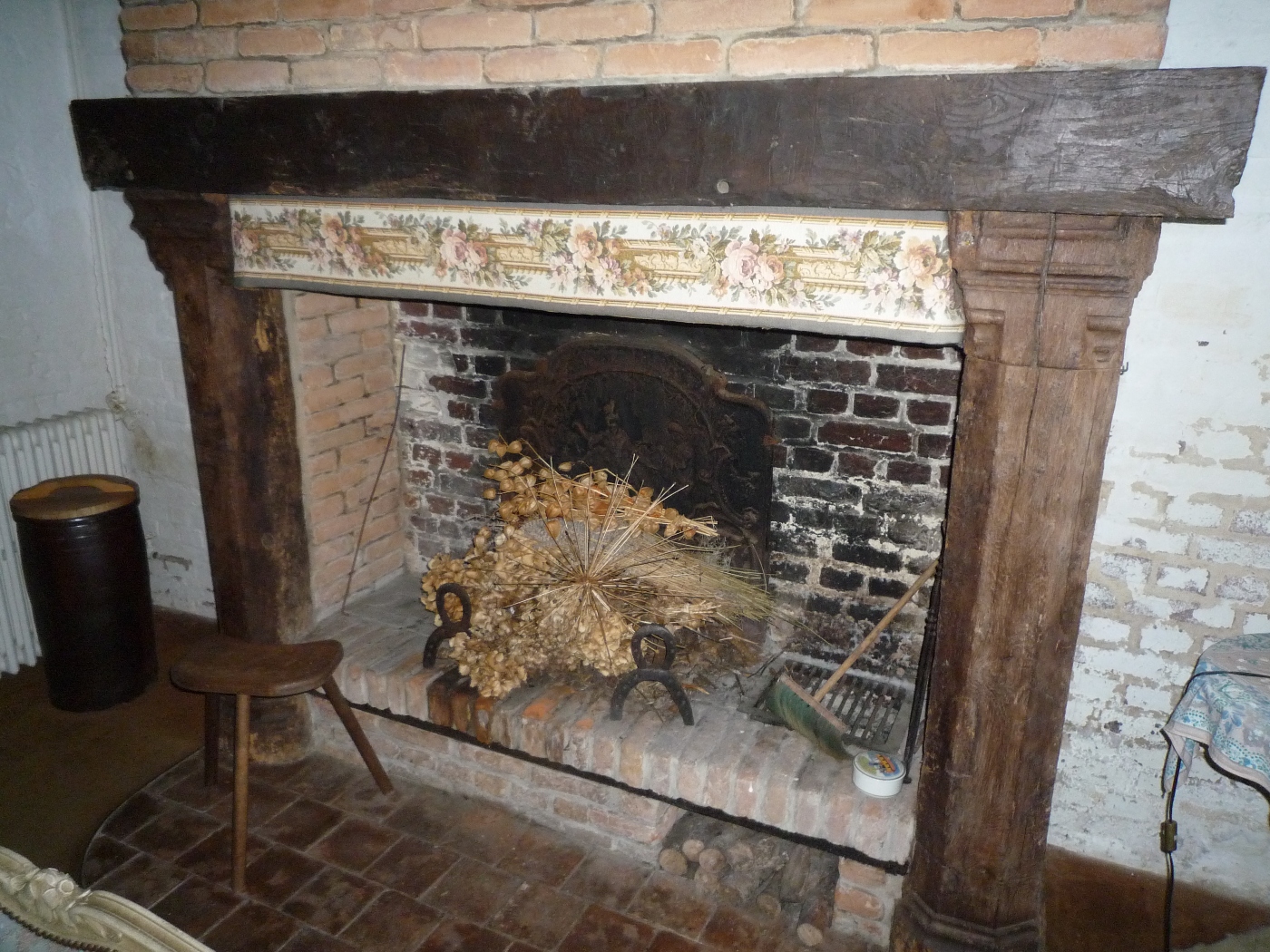 Cheminée en briques avec jambages en bois sculpté dans une maison à vendre proche d'Etretat